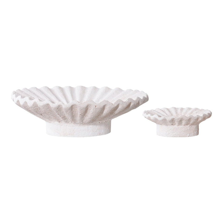 Two white bowls with textured designs on a white background