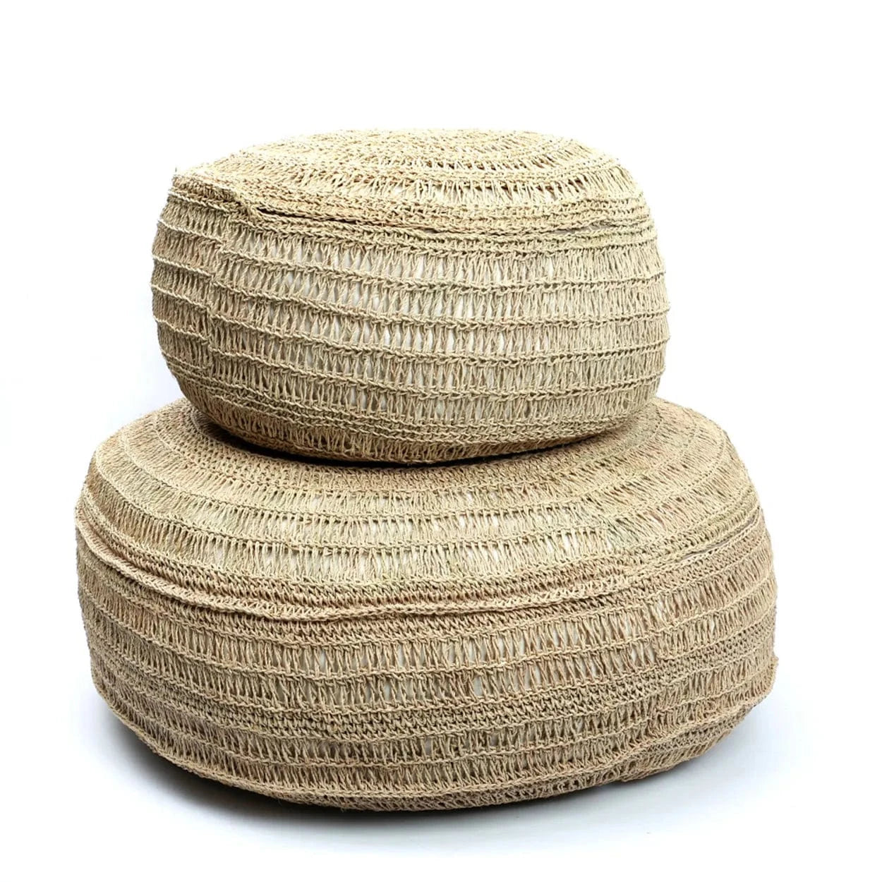 Two woven beige ottomans stacked on a white background