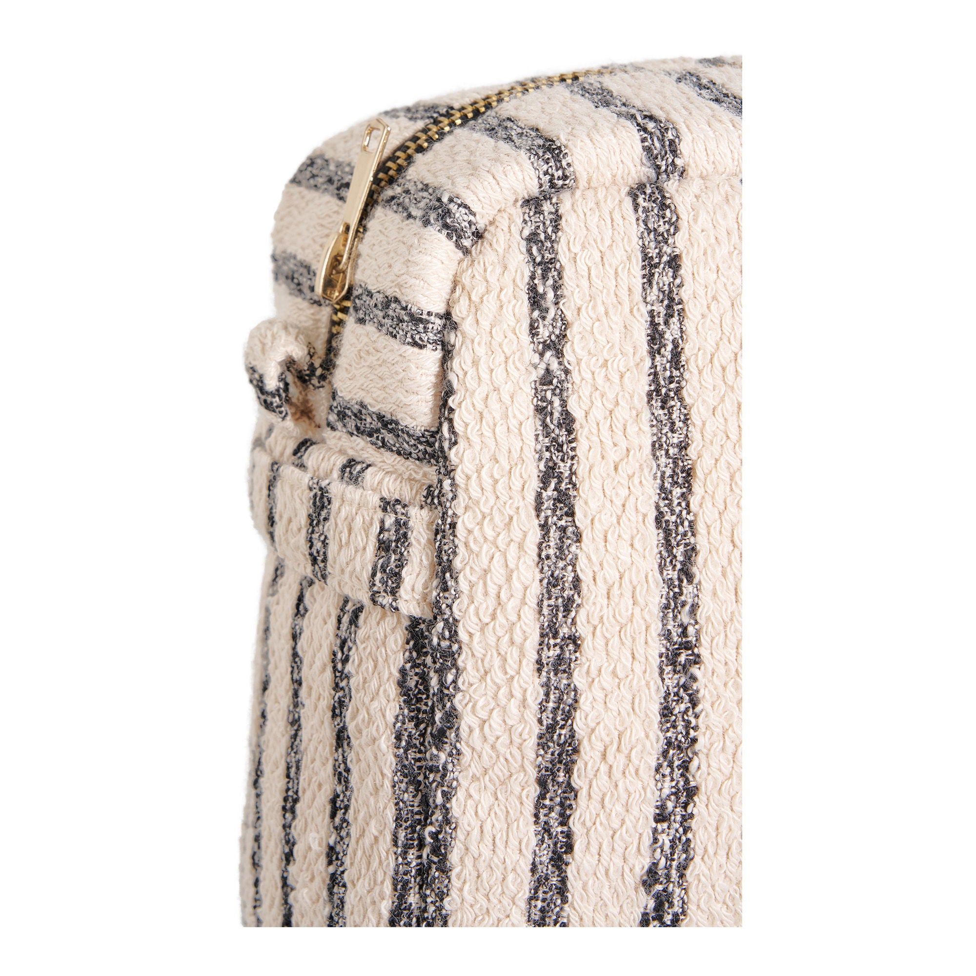 Close-up of a striped fabric with a gold zipper on a white background
