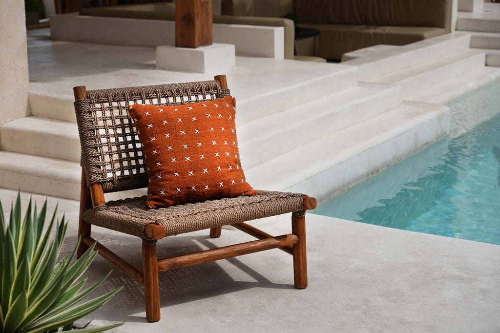 Terracotta white cotton Zillion Kiss Cushion Cover on poolside chair