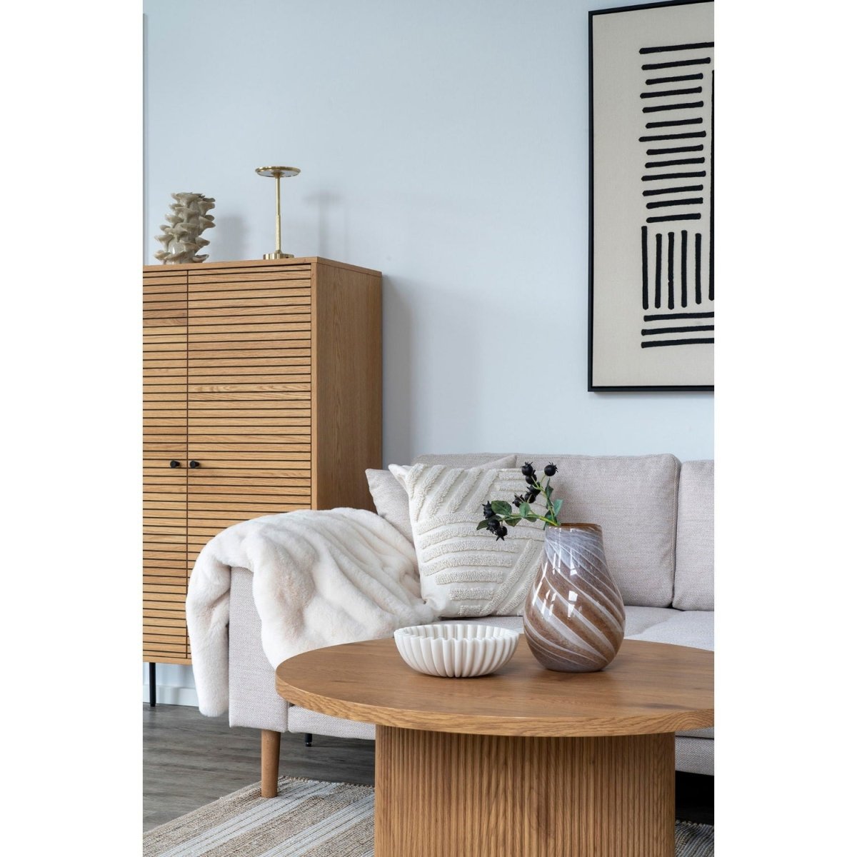 Modern living room with a sofa, coffee table, and decorative items.
