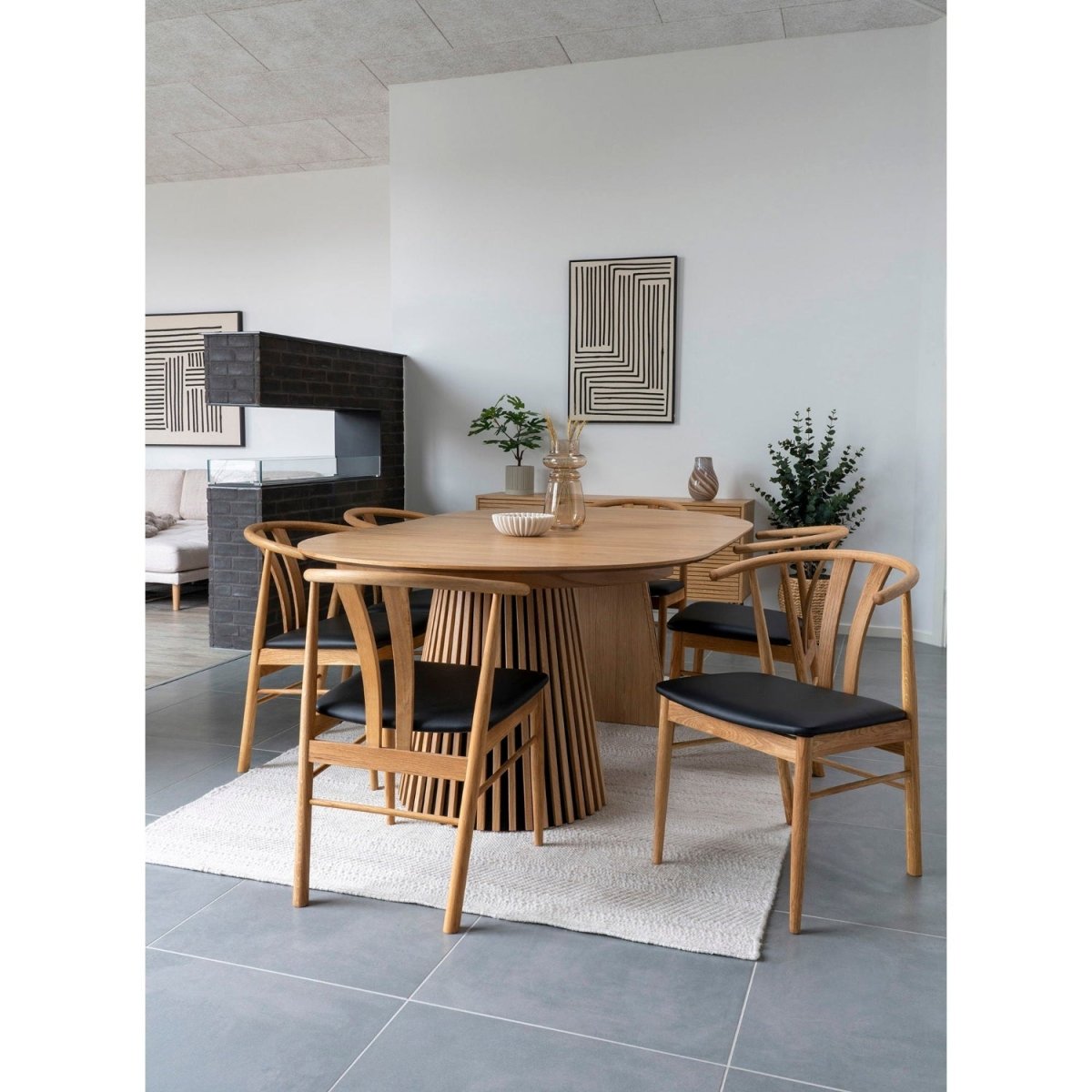 Dining area with wooden table and chairs in a modern room.