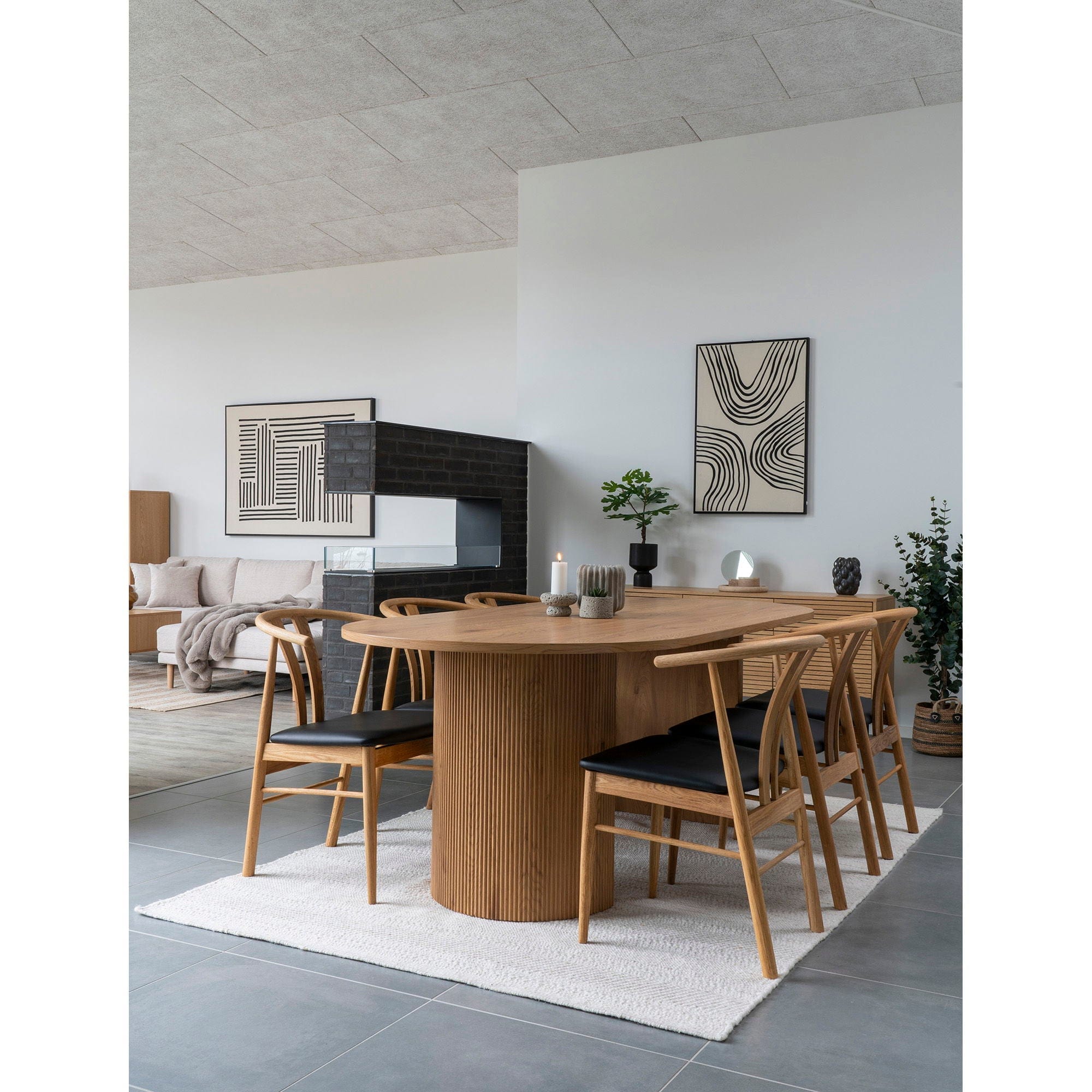 Dining room with wooden table and chairs in a modern interior setting.