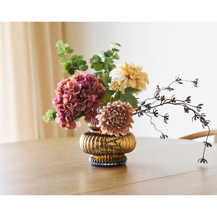 Decorative vase with flowers on a wooden surface