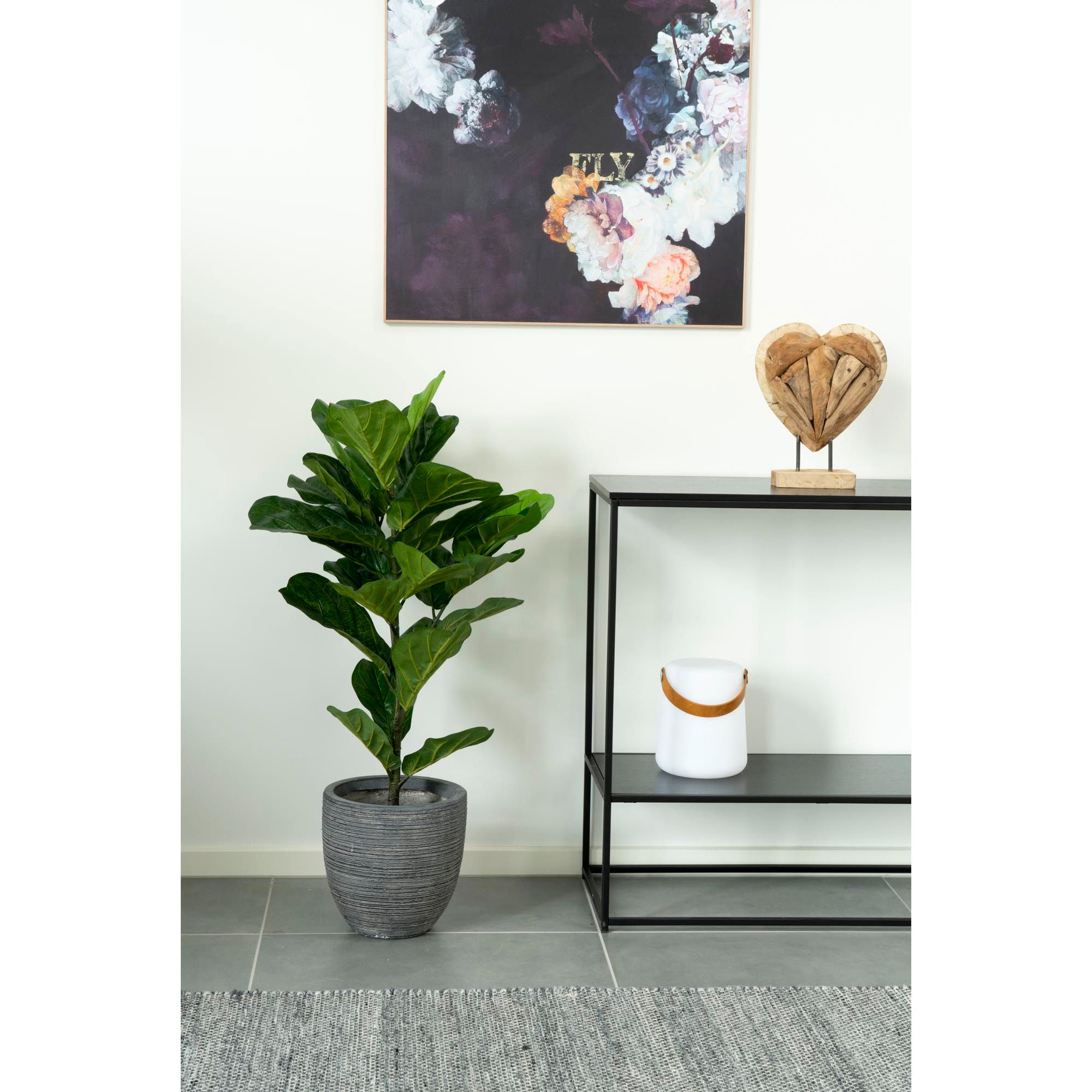 Potted plant in a room with a shelf and decorative items