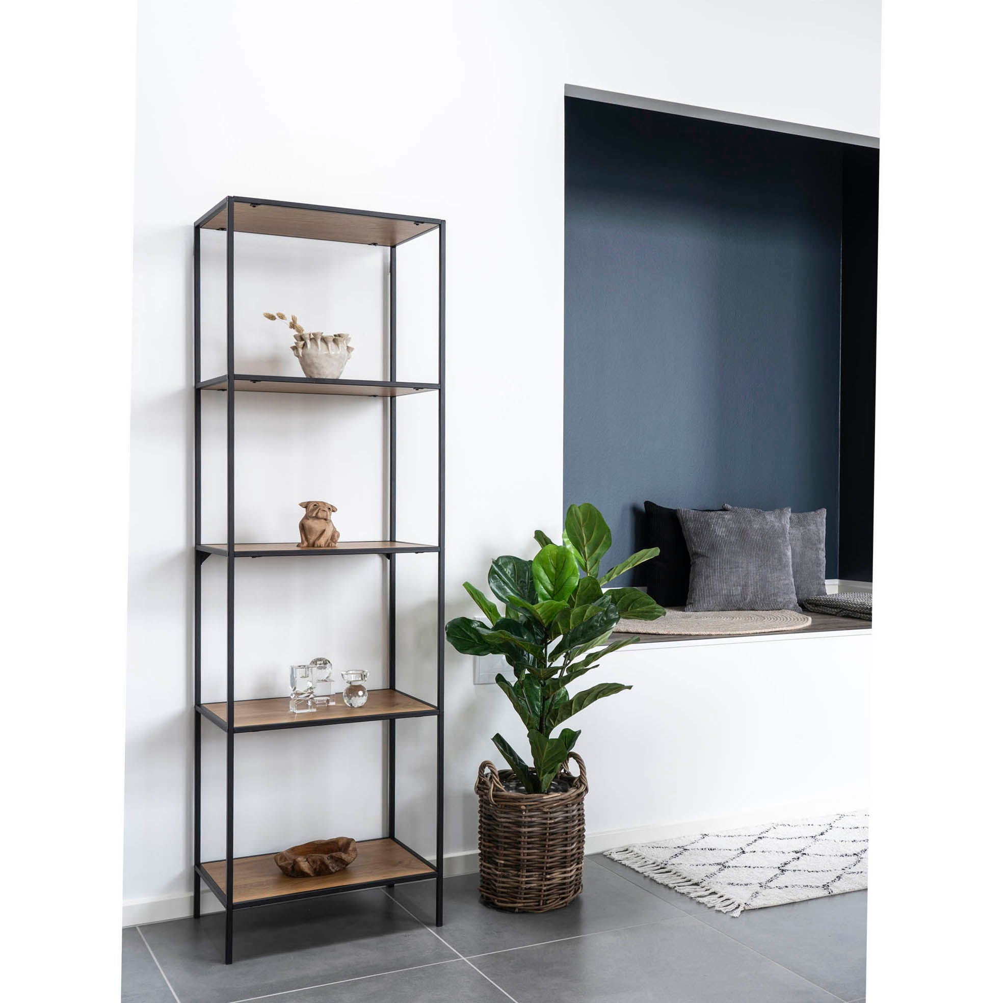Tall metal shelf with wooden shelves in a room with a plant and seating area.