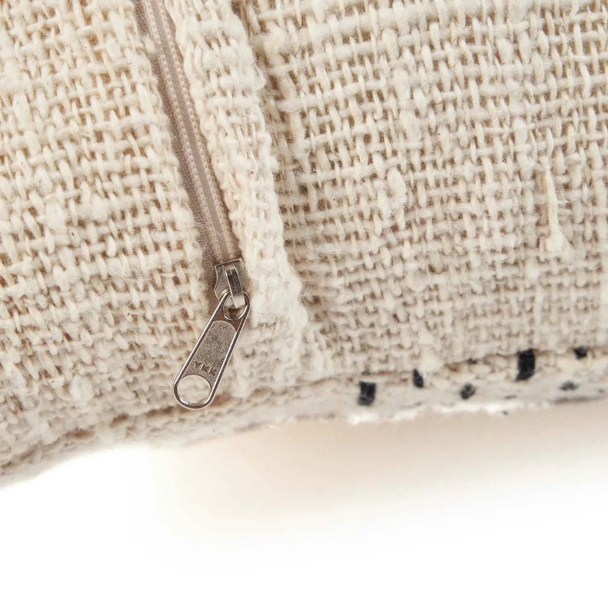 Close-up of a textured fabric surface with a zipper