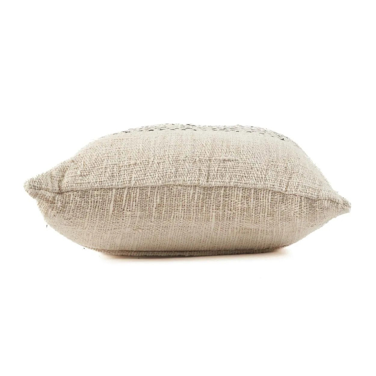 Textured beige pillow on a white background