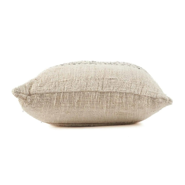 Textured beige pillow on a white background