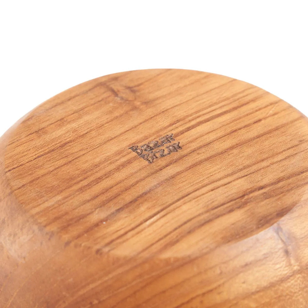 Close-up of a wooden product with a visible brand logo on a white background