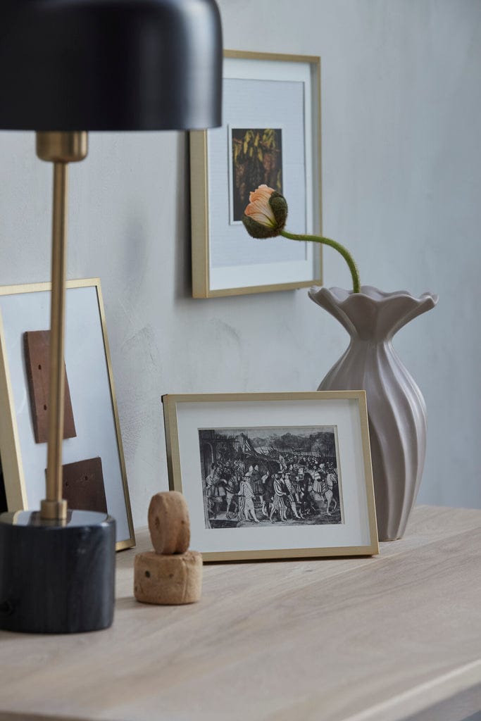 Austin Photo Frame 20 cm x 15 cm in light gold on a stylish decor setting.