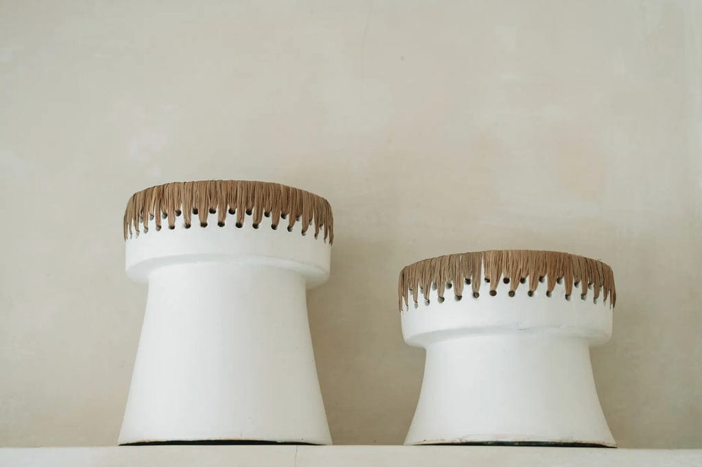 Pretty Candle Holder in white terracotta with raffia accent, stylish home decor piece.