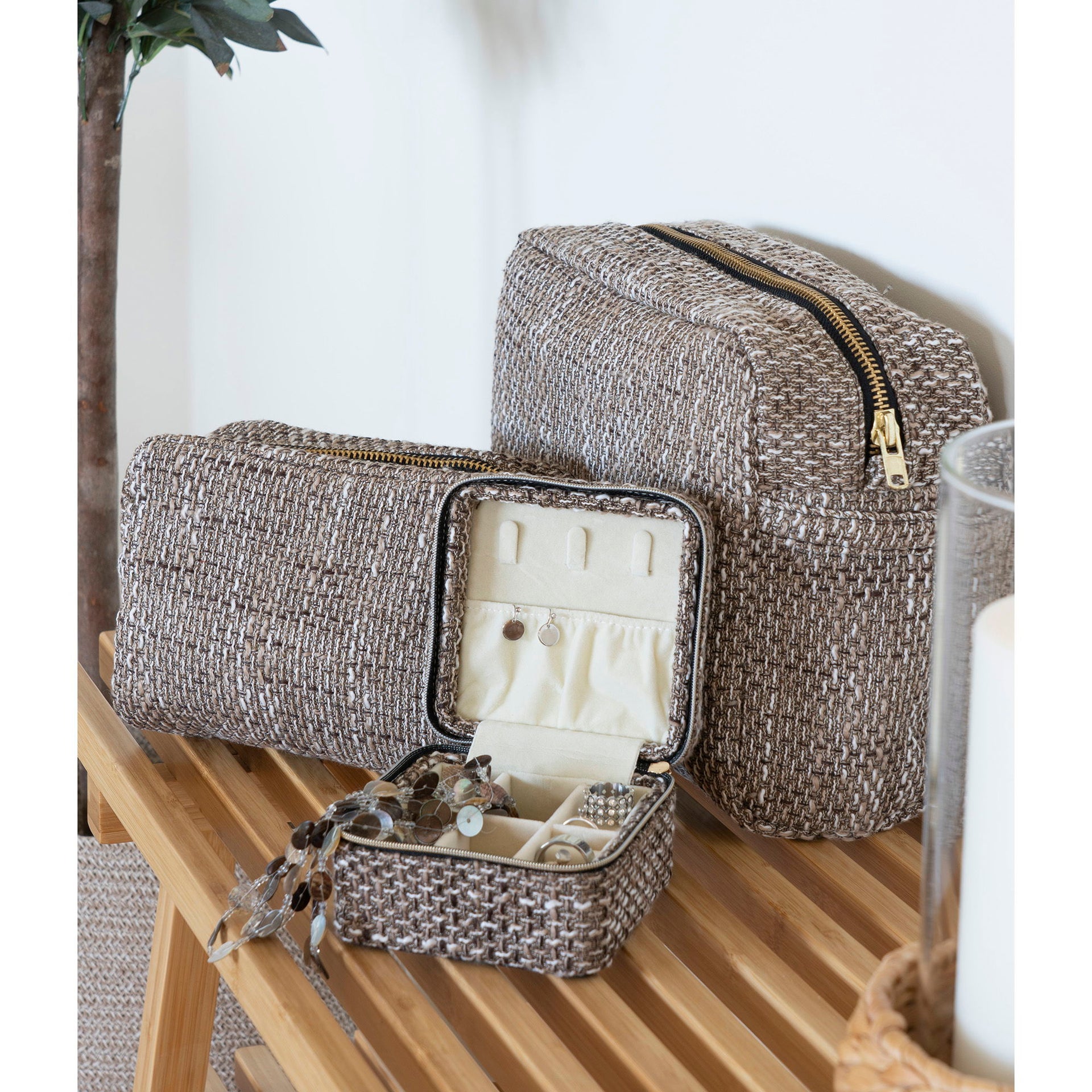 Woven jewelry box with open lid on a wooden surface