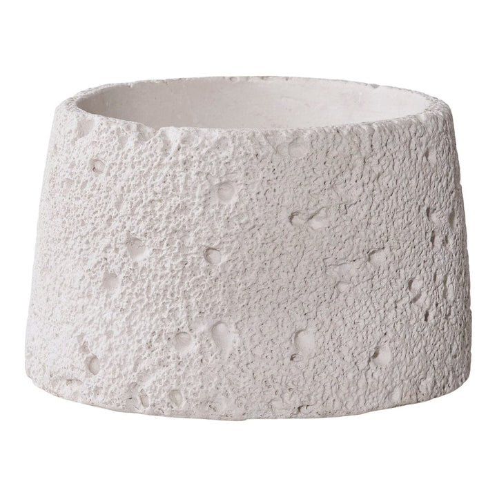 Textured white ceramic planter on a plain background
