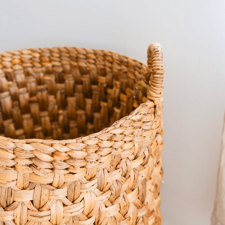 Close-up of a woven basket with a plain background