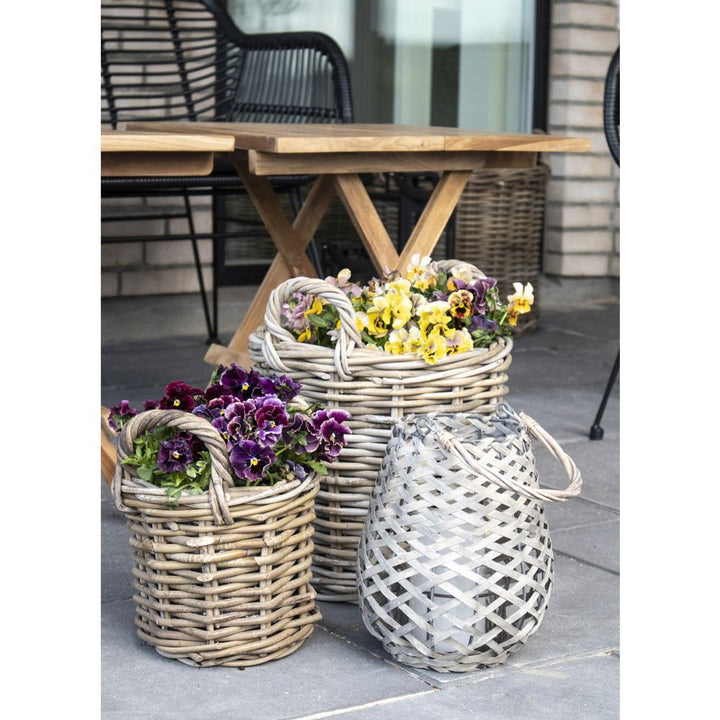 Wicker baskets with flowers on a patio