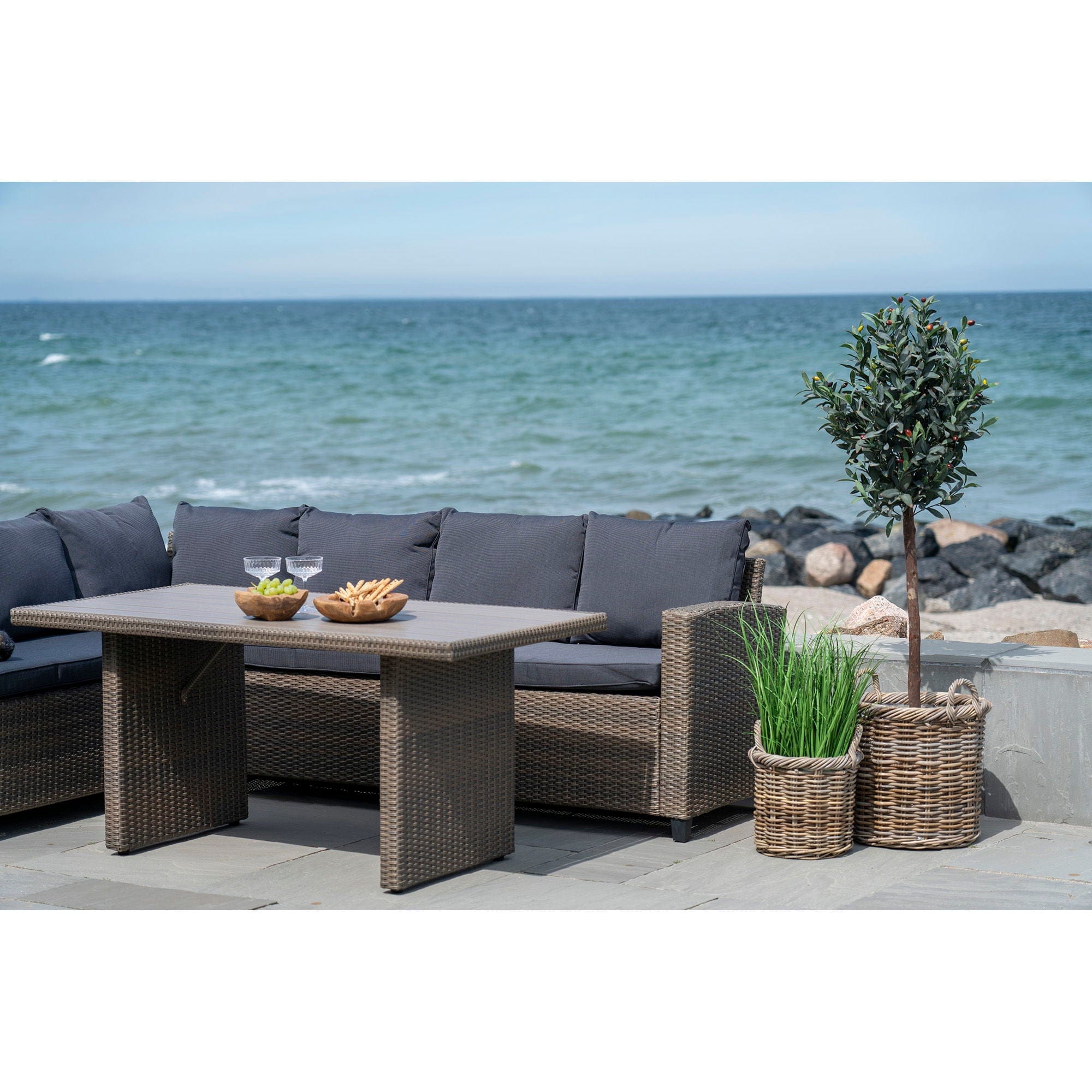 Outdoor patio set with table and sofa by the ocean