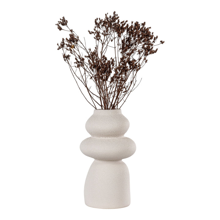 White ceramic vase with dried flowers on a white background