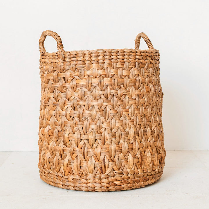 Woven basket with handles on a white background