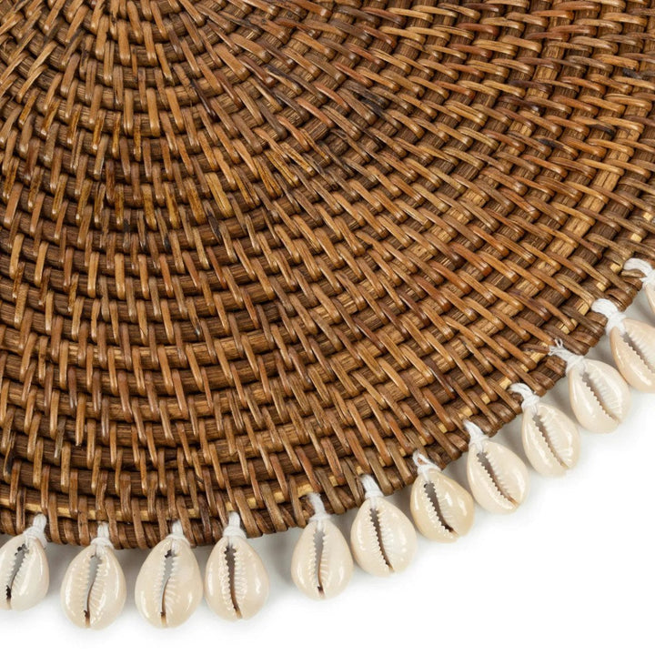 Brown woven placemat with shell fringe on a white background