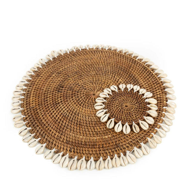 Round woven placemat with shell trim on a white background