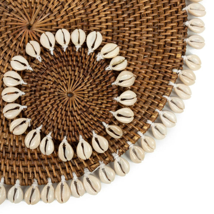 Woven placemat with cowrie shell border on a white background
