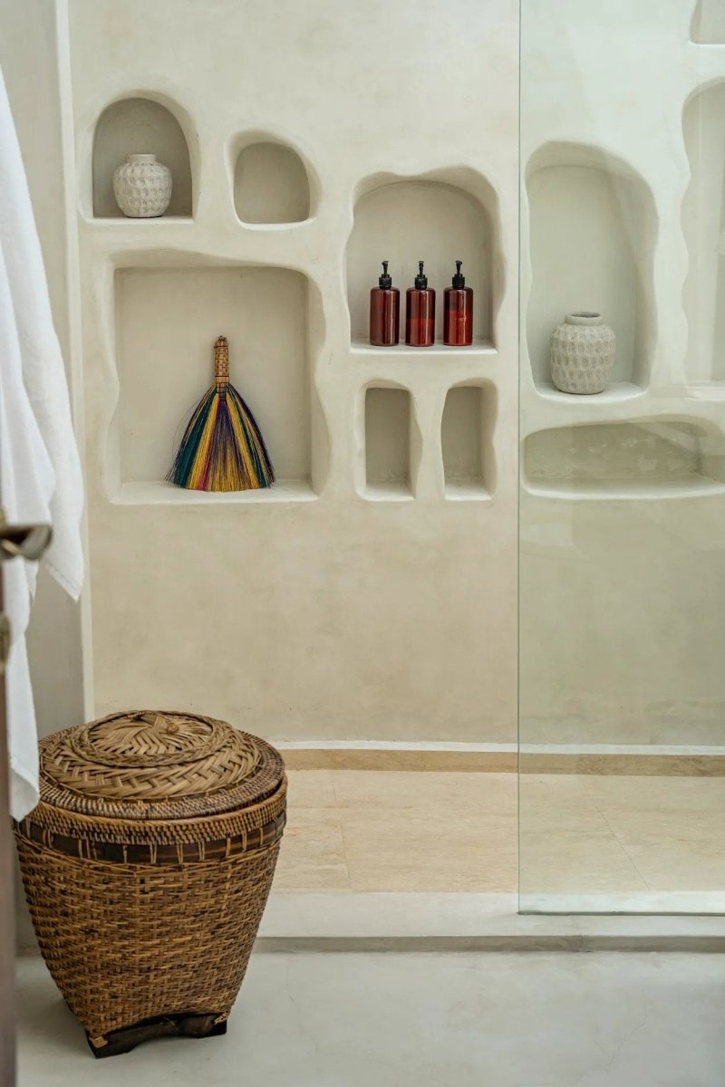 Beige wall with built-in shelves and a wicker basket on the floor.