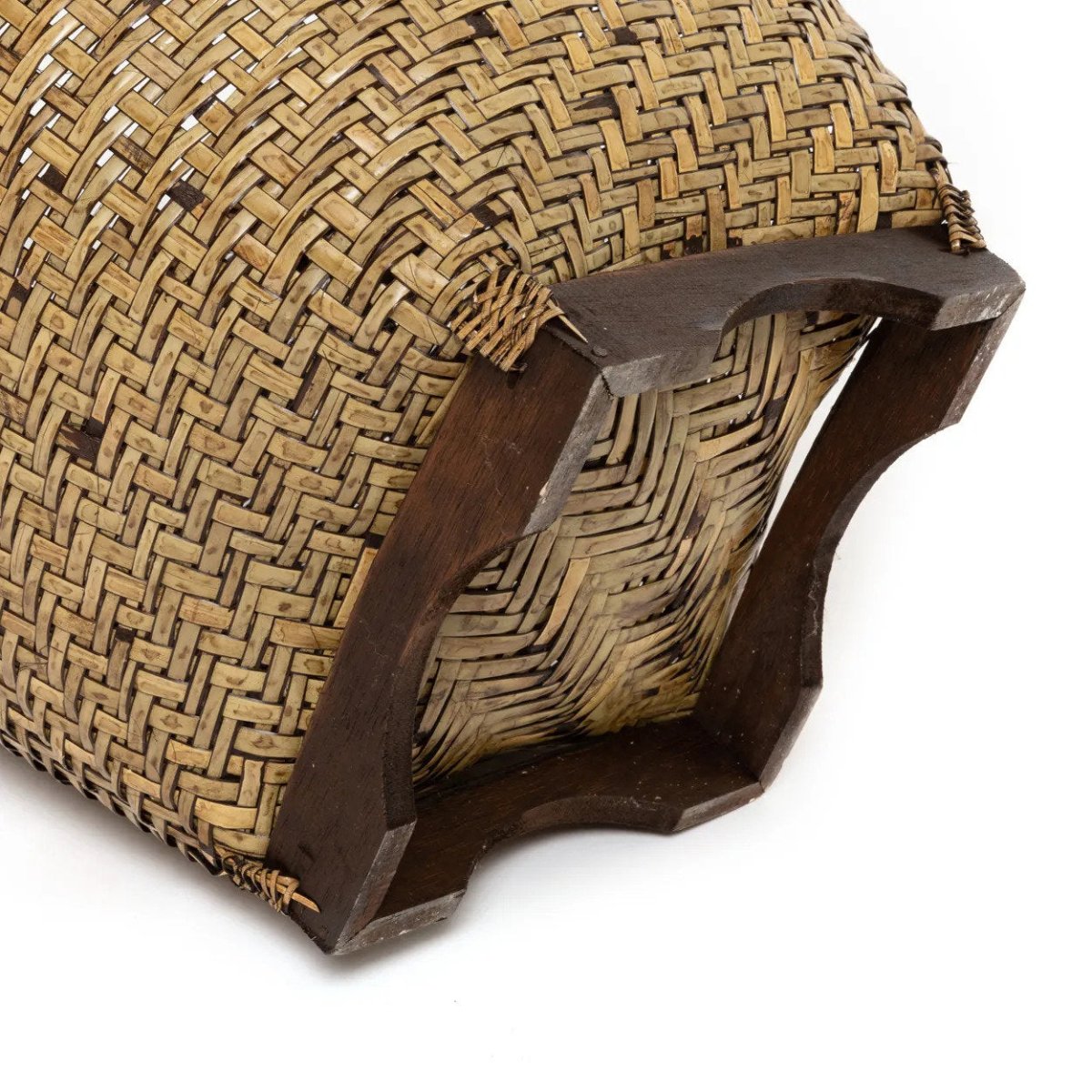 Woven straw basket with a wooden base on a white background