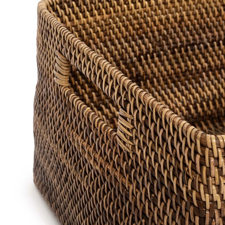 Close-up of a woven brown basket with a white background