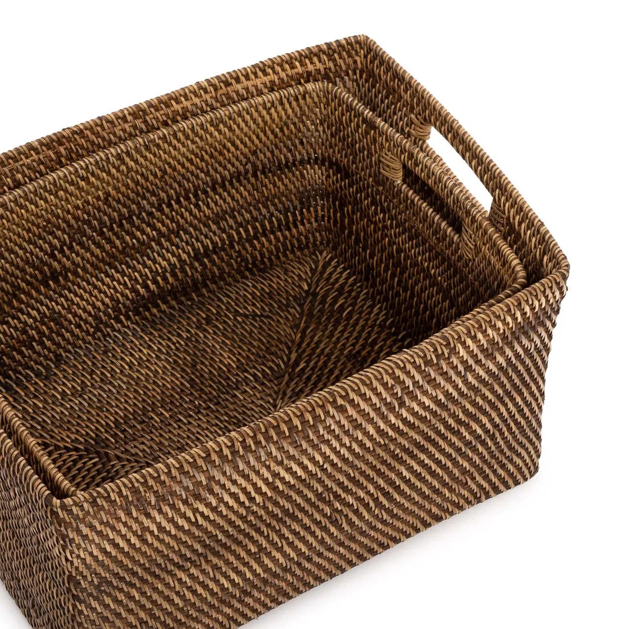 Woven brown basket with handles on a white background