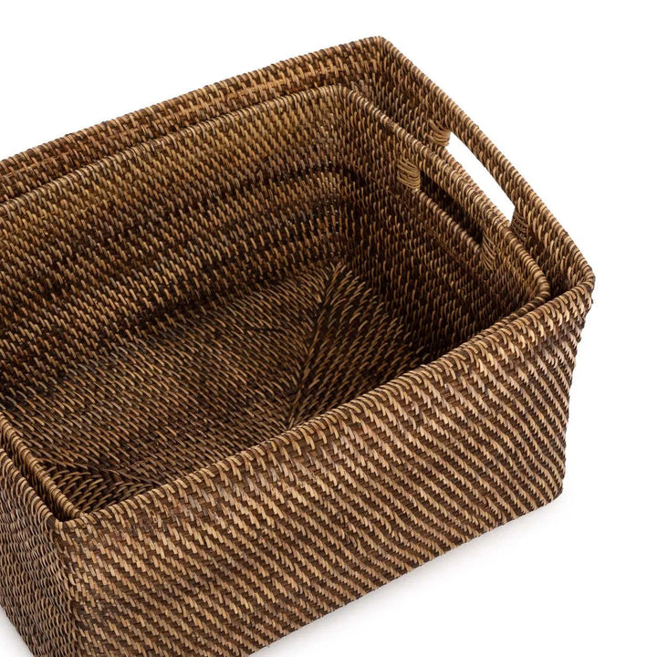 Woven brown basket with handles on a white background