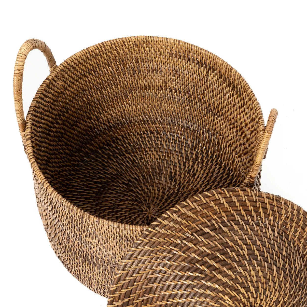 Woven brown basket with handles on a white background