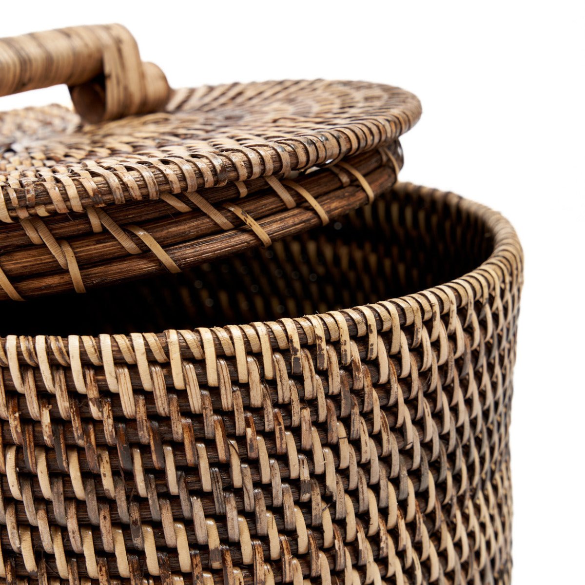 Woven basket with a lid on a white background