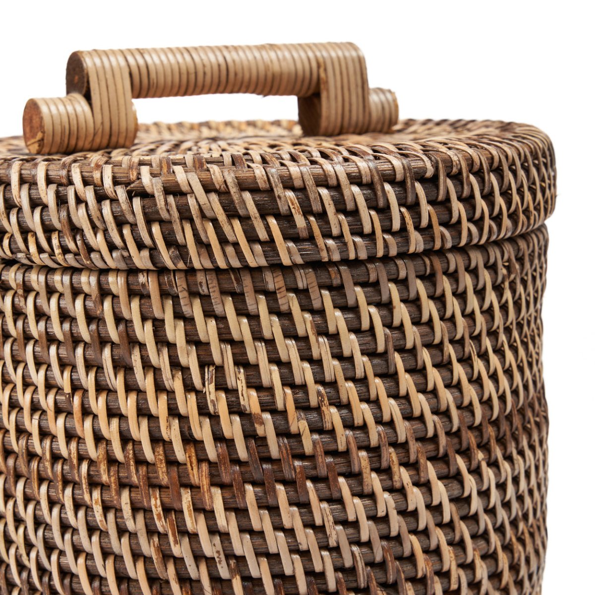 Woven rattan basket with a lid on a white background