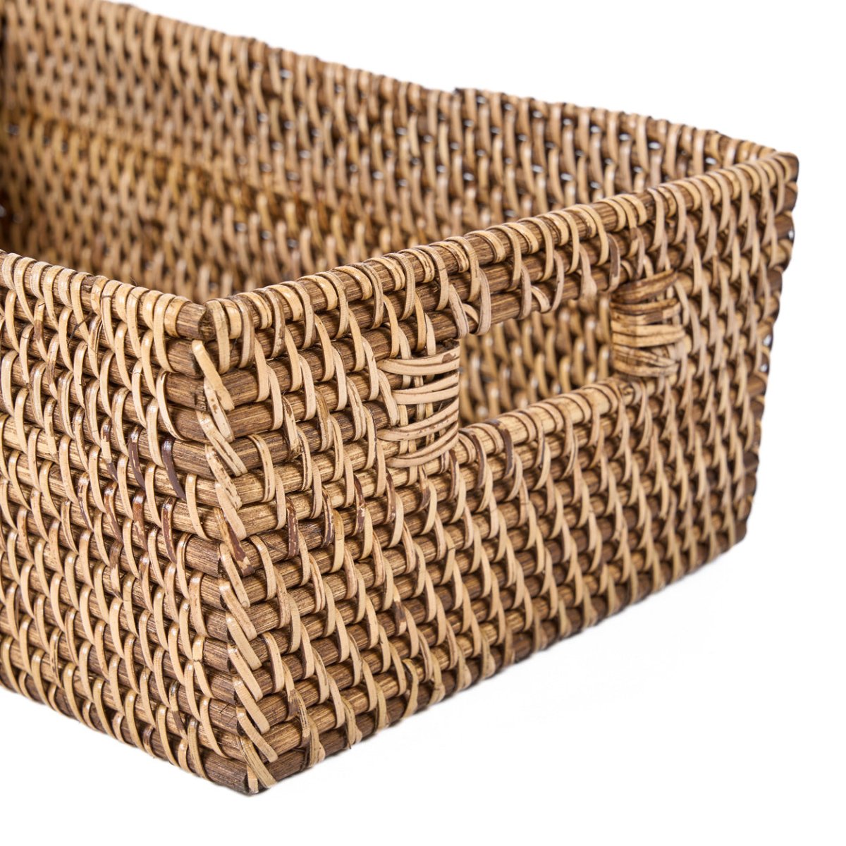 Woven rattan storage basket on a white background