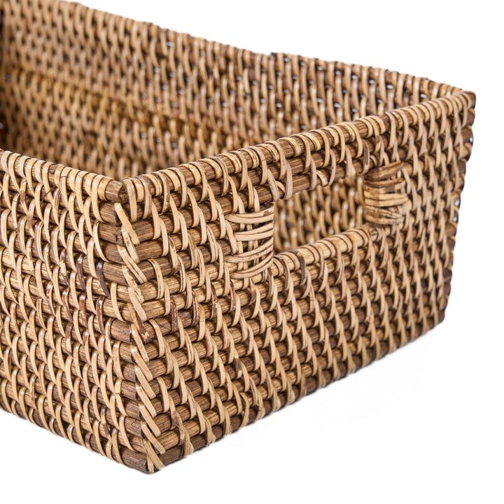 Woven rattan storage basket on a white background