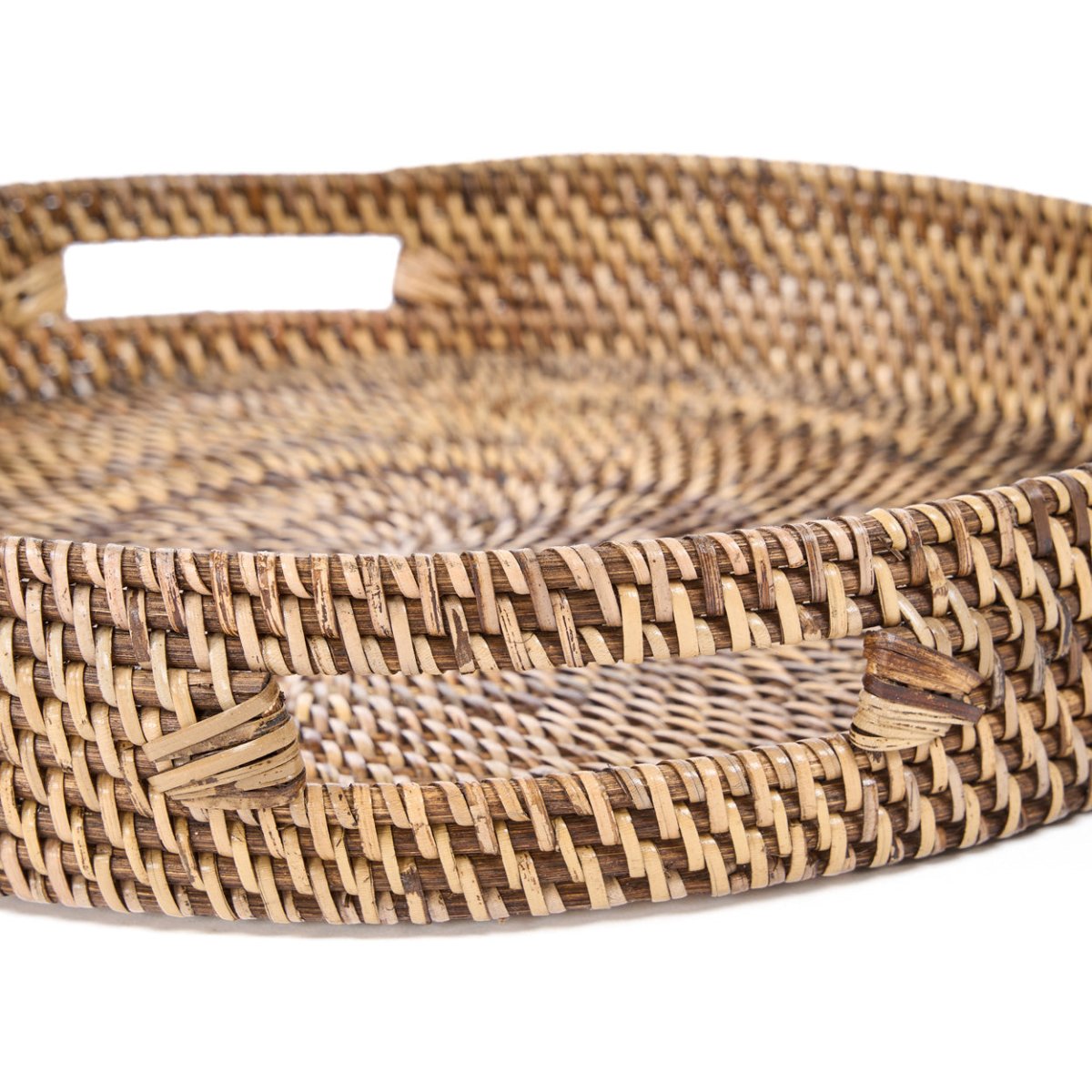 Woven rattan tray with a natural brown pattern on a white background