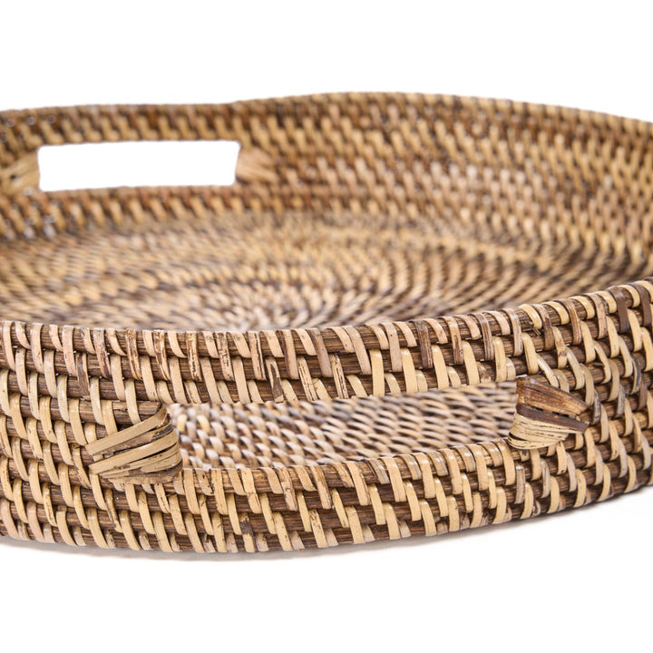 Woven rattan tray with a natural brown pattern on a white background