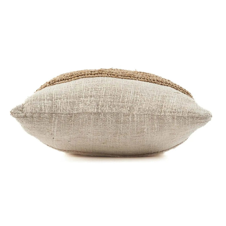 Textured pillow with a natural color scheme on a white background