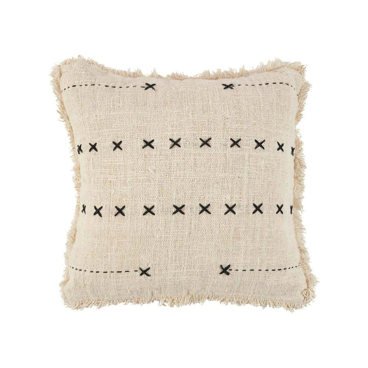 Beige pillow with black cross patterns on a white background