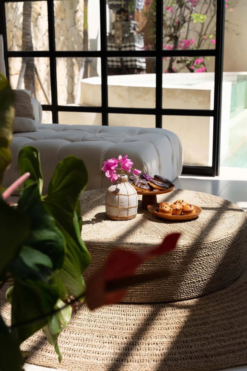 Living room with a gray sofa, coffee table, and decorative items.