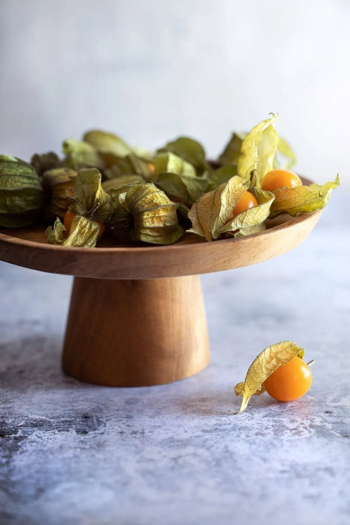 Wooden stand withPhysalis fruit on a marble surface