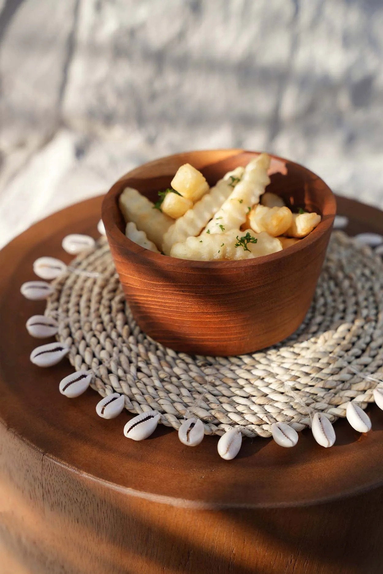 Wooden bowl with food on a textured placemat