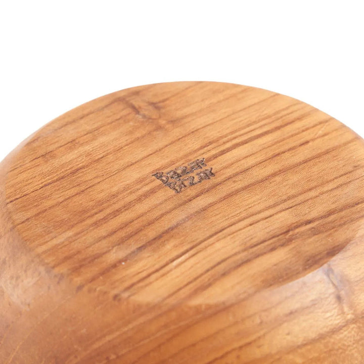 Close-up of a wooden product with a visible brand logo on a white background