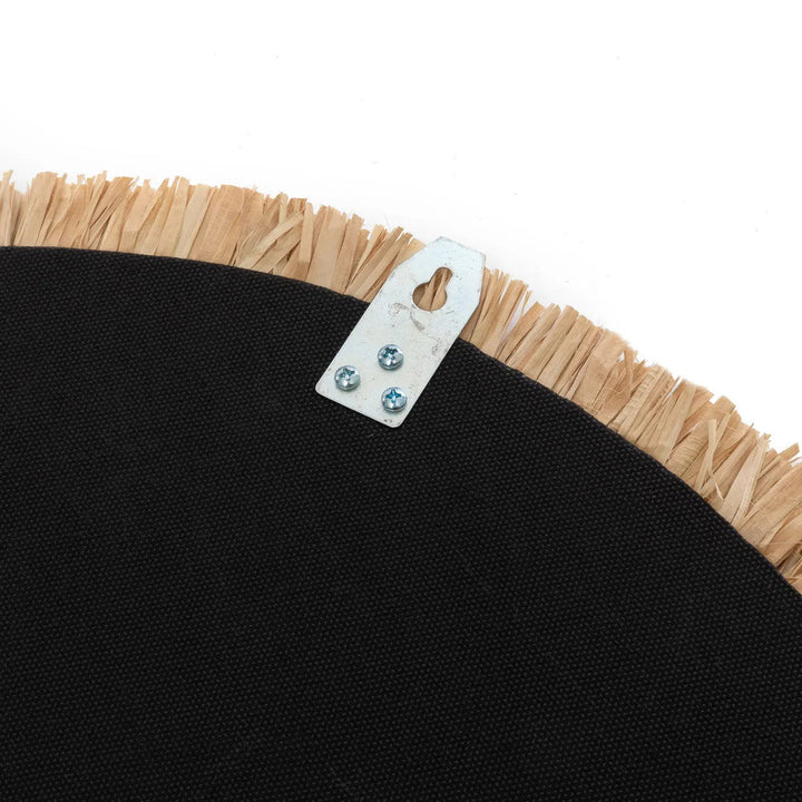 Back of mirror with beige fringes and a metal tag on a white background