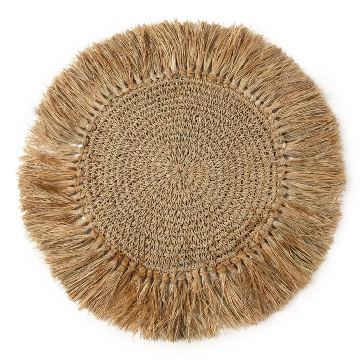 Round woven mat with fringed edge on a white background