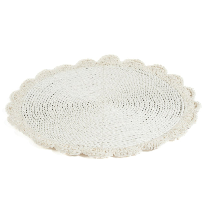 Round white crocheted mat on a white background