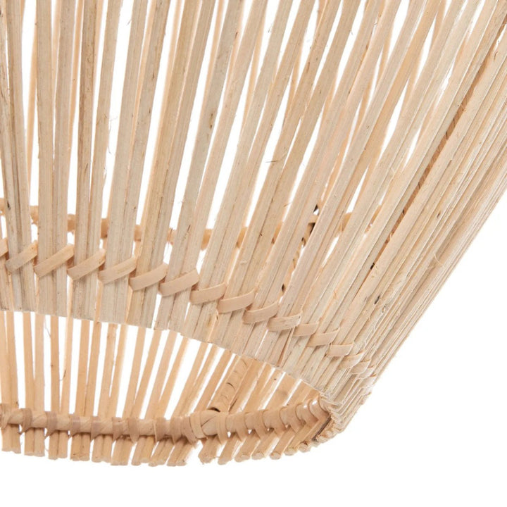 Close-up of a woven basket with natural wooden sticks on a white background