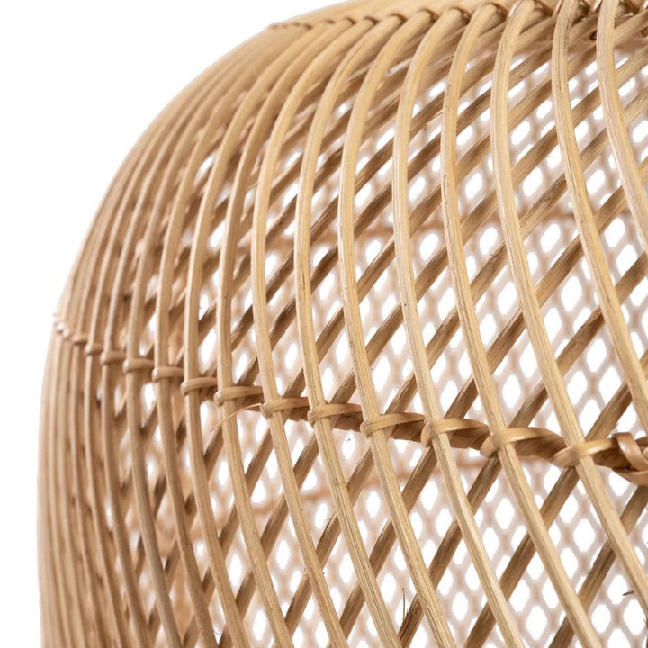 Close-up of a woven rattan lampshade on a white background