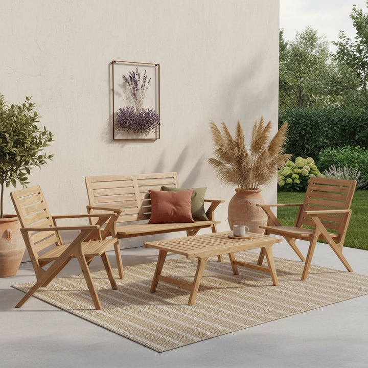 Outdoor patio set with wooden chairs, table, and cushions on a rug.